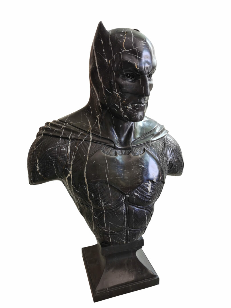Picture of a black Portorro marble sculpture of the Batman, by French artist Leo Caillard, represented at Galerie Montmartre, Paris, France