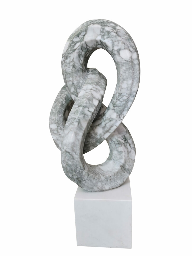 Picture of a marble sculpture titled Infinity Stone, created by French artist Leo Caillard, represented at Galerie Montmartre, Paris, France